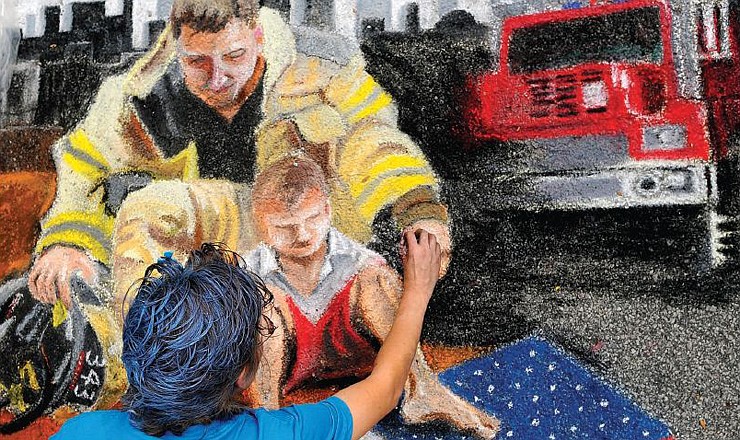 In this file photo, Jefferson City resident Jennifer Neff details her street chalk artwork depicting her son Eli and a local firefighter during the Street Art Fair in 2011. The 2012 fair will be held Saturday, Sept. 8. 