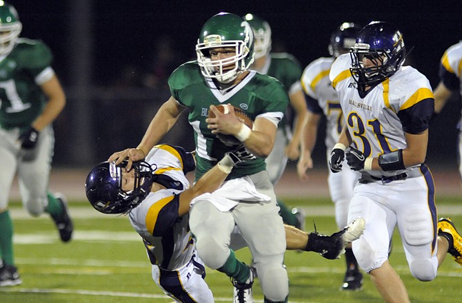 Blair Oaks quarterback Daniel Castillo breaks a Hallsville tackle on his way to a touchdown Friday at the Falcon Athletic Complex.