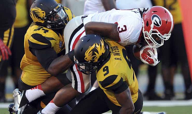 Georgia running back Todd Gurley (3) carries the ball against Missouri defensive lineman Sheldon Richardson (34) and Braylon Webb during the first quarter of an NCAA college football game Saturday, Sept. 8, 2012, in Columbia, Mo. 