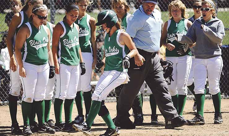 Blair Oaks players watch Payton Staggs touch home plate after her two-run home run against Lutheran South in Saturday's Capital City Softball Invitational at Binder Park near Jefferson City.