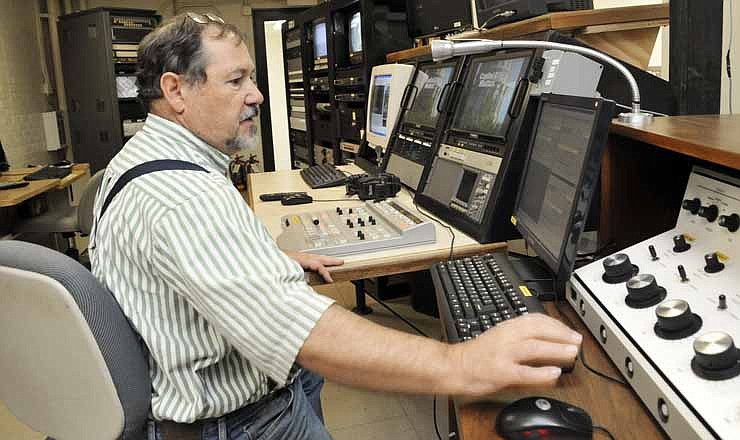 Art Gerhard sits behind the controls of the board at the studio of JCTV. Gerhard has worked at JCTV for several years and has a number of duties at the small station.
