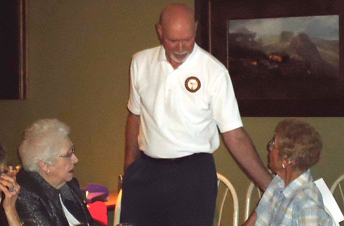 Air Force veteran John Clark, center, visits with attendees at a recent meeting of the Central Missouri Chapter of Ex-American Prisoners of War.