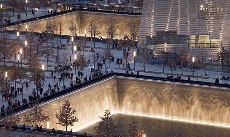 In this Dec. 20, 2011 file photo, visitors to the National September 11 Memorial in New York walk around its twin pools. The foundation that runs the memorial estimates that once the roughly $700 million project is complete, it will cost $60 million a year to operate. 