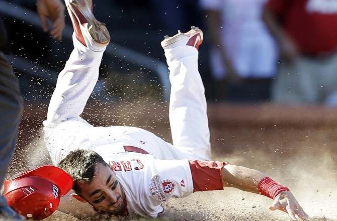 The Cardinals' Matt Carpenter scores the game-winning run on a single by Allen Craig during the 10th inning Sunday in St. Louis.