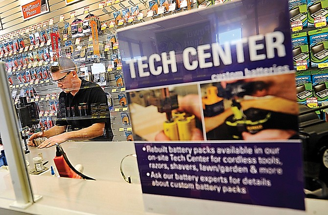 Owner Steve Dullard works on repairing a customer's cordless drill battery pack in the tech center at the new Jefferson City Batteries Plus store on Monday afternoon.
