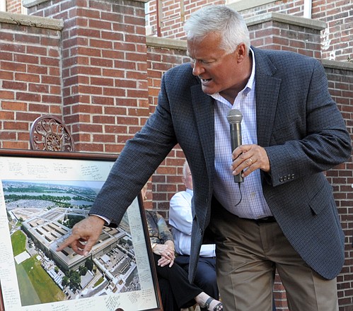 Ret. Col. Rod Burnett, USMC, points to a signed photo of the Pentagon, as he describes Tuesday what he saw 11 years ago when he returned to his office at the Pentagon. Burnett was the featured speaker at the Remembering 9/11 event at the Cole County Historical Society.