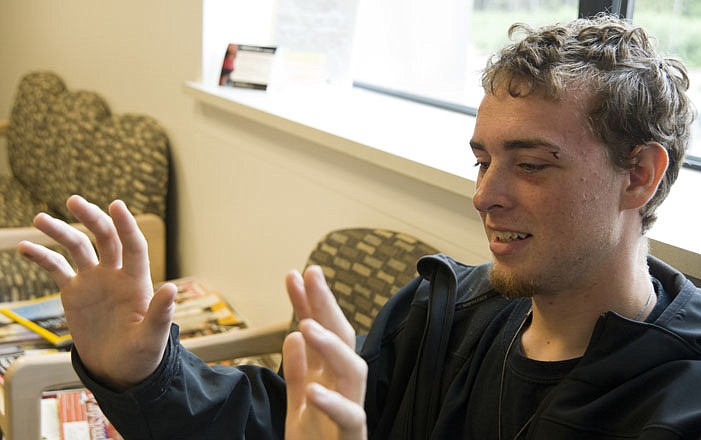 Ryan Harris shows blisters on his hands Monday he developed while gripping the edge of a 4-foot-square fish bin for more than a day in the open ocean.