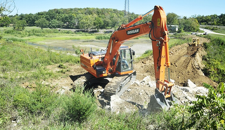 
A small creek continues to run through the heart of what was once Renn's Lake, which is now overgrown with native grasses, reeds and small trees. Heavy equipment operators from Cole County Public Works have begun the process of breaching the dam at the south end of Renn's Lake. 