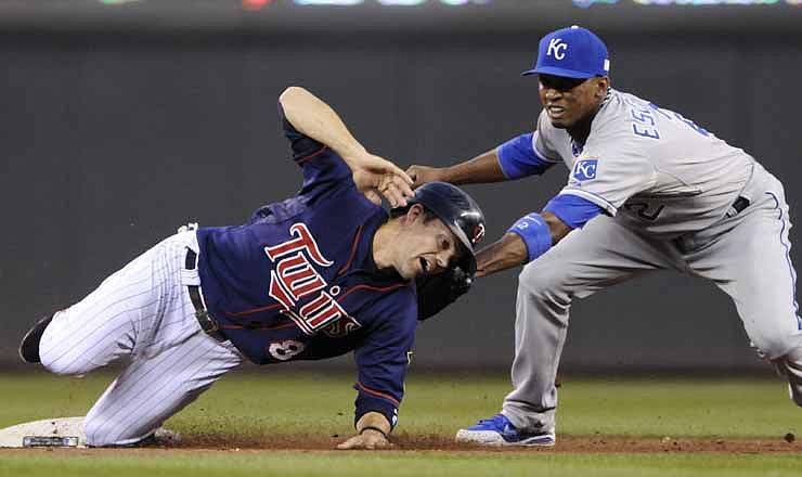 Jamey Carroll of the Twins tries to avoid the tag of Royals shortstop Alcides Escobar while attempting to steal second base in the first inning of Tuesday's game in Minneapolis. Carroll was out on the play.