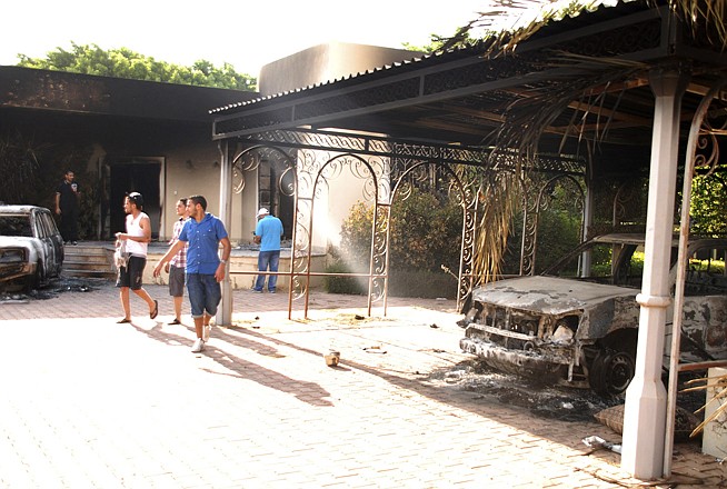 Libyans walk on the grounds of the gutted U.S. consulate Wednesday in Benghazi, Libya, after an attack that killed four Americans, including Ambassador Chris Stevens. The four Americans and several Libyan security guards were killed when a mob of protesters and gunmen overwhelmed the U.S. Consulate in Benghazi, setting fire to it in outrage over a film that ridicules Islam's Prophet Muhammad. 