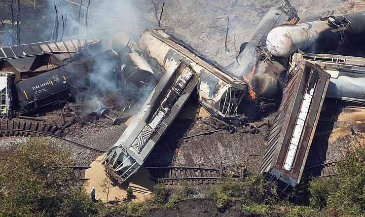 This July 11, 2012 aerial file photo, a freight train is seen after an early morning derailment in Columbus, Ohio. Part of the freight train carrying ethanol derailed and caught fire, shooting flames skyward into the darkness and prompting the evacuation of a mile-wide area as firefighters and hazardous materials crews monitored the blaze. For two decades, one of the nation's most common types of rail tanker, known as a DOT-111, a workhorse of the American rail fleet, has been allowed to haul hazardous liquids from coast to coast even though transportation officials were aware of a dangerous design flaw that almost guarantees the car will tear open in an accident. 