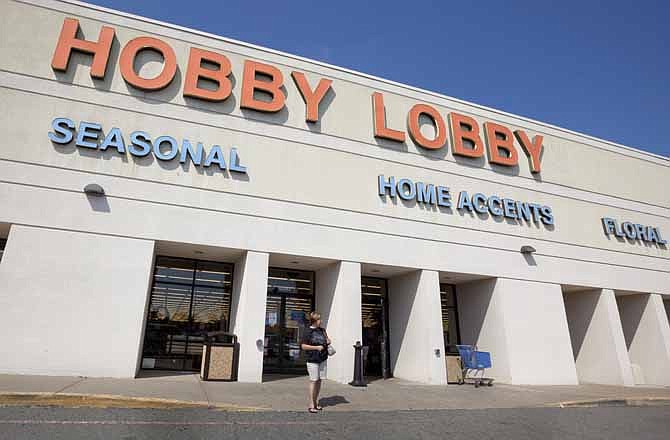 A woman walks from a Hobby Lobby Inc., store in Little Rock, Ark., on Sept. 12, 2012.