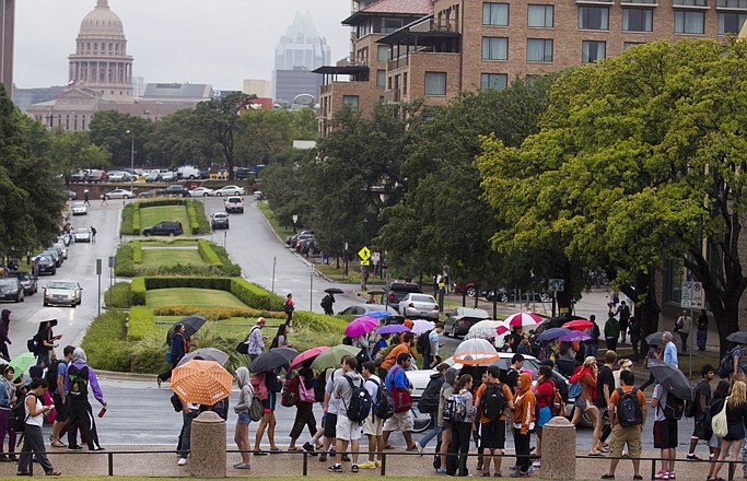 University of Texas students stand outside Friday after evacuating buildings at The University of Texas in Austin, Texas. Thousands of people streamed off university campuses in Texas, North Dakota and Ohio on Friday after phoned-in bomb threats prompted evacuations and officials warned students and faculty to get away as quickly as possible.