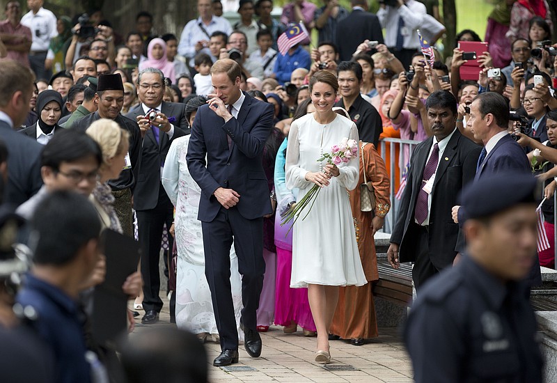 Prince William and his wife Kate, the Duke and Duchess of Cambridge, center, take a walk Friday through a central city park in Kuala Lumpur, Malaysia. Prince William and Kate are on a nine-day tour of the Far East and South Pacific in celebration of Queen Elizabeth II's Diamond Jubilee.