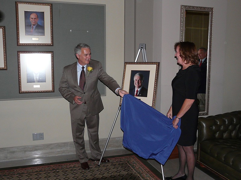 Outgoing Missouri Senate President Pro Tem Rob Mayer, R-Dexter, and his wife, Nancy, reveal the portrait photograph that will be hung on the wall in the state Senate's Pershing Gallery, along with pictures of previous Senate pro tems.