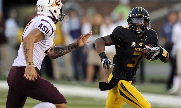Missouri's E.J. Gaines, right, runs past Arizona State punter Josh Hubner for a 44-yard gain after taking a handoff from teammate Marcus Murphy who initially handled the punt during the second quarter of an NCAA college football game on Saturday, Sept. 15, 2012, in Columbia, Mo.