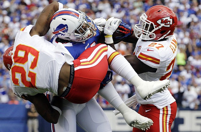 Dorian Dickerson of the Bills tries to escape the grasp of Chiefs teammates Eric Berry (29) and Abram Elam (27) during Sunday's game in Orchard Park, N.Y.