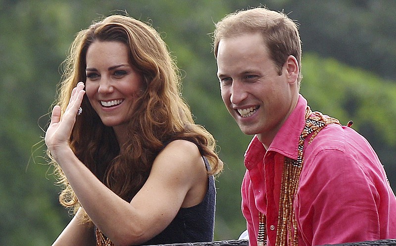 Britain's Prince William and his wife Kate, the Duke and Duchess of Cambridge, smile Monday as they watch a shark ceremony while arriving at Marapa Island, Solomon Islands.