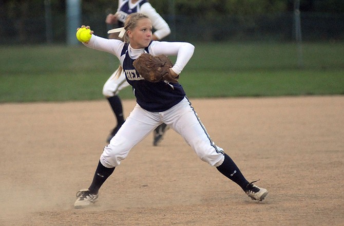 Helias third baseman Paige Bange throws to first for an out during Tuesday's game against Fatima at Duensing Field.