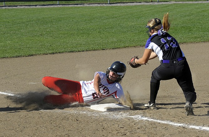 Madison Painter of Jefferson City avoids the tag attempt at third by Riley Wilson of Hickman during Tuesday afternoon's game at Lincoln Field.