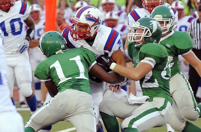 Blair Oaks teammates Dominic Jamerson and Zach Holstein combine on a tackle during a game earlier this season against Moberly at the Falcon Athletic Complex. Defense should play a key role in Friday night's home game against School of the Osage.