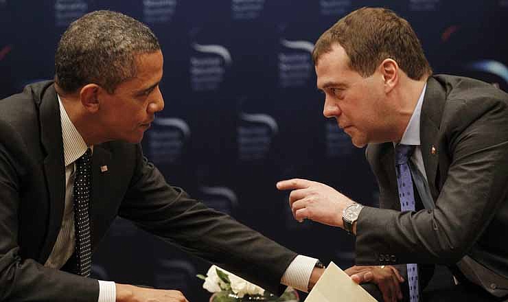 In this March 26, 2012, file photo, President Barack Obama, left, chats with Russian President Dmitry Medvedev during a bilateral meeting at the Nuclear Security Summit in Seoul, South Korea. An open microphone caught Obama telling Russia's outgoing president that he needed space to work out their disagreements over U.S. missile defense plans. "After my election, I have more flexibility," Obama quietly told Medvedev, who said he would carry that message home. Republican presidential candidate Mitt Romney called it evidence that Obama is hiding a secret agenda for a second term.
