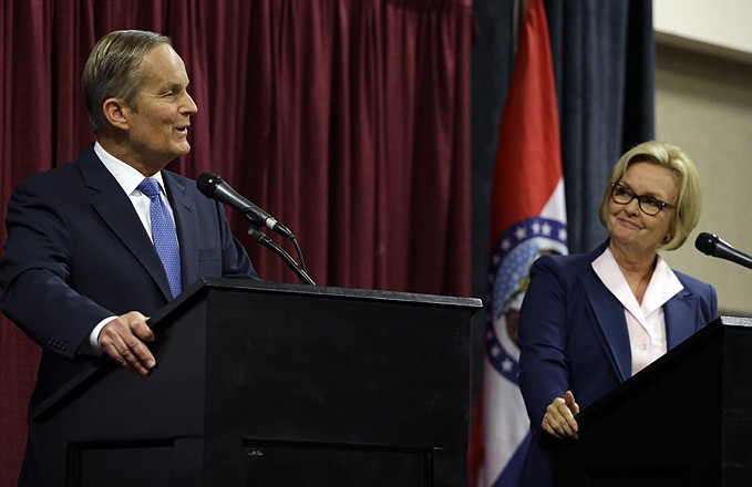 Republican challenger Rep. Todd Akin, left, speaks as Democratic Sen. Claire McCaskill stands by Friday during the first debate in the Missouri Senate race in Columbia.