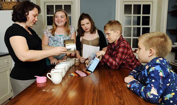 Kursten Schwarz prepares a batch of hot chocolate for her children, from left, Isabela, Alessandra, Gideon and Gabriel before they all head up to their beds in the historic Col. Bolton home in Wardsville, Mo.