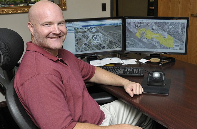 Jefferson City's GIS manager, Greg Resz, sits at his desk in his municipal building office.