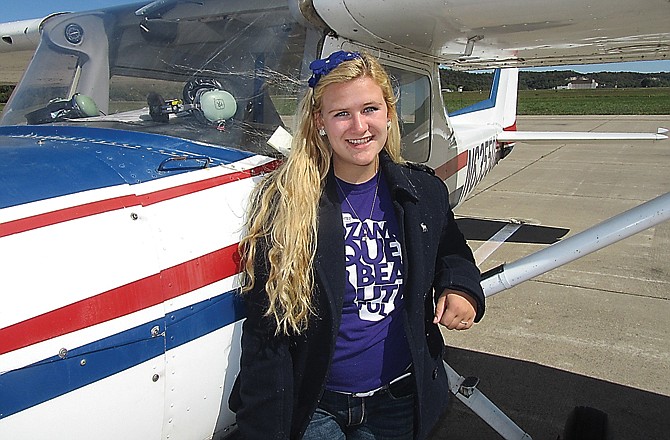 Anastasia Crenshaw poses beside her single-engine Cessna on Sunday at the Jefferson City Memorial Airport. At 17, she's one of the youngest pilots in Missouri.