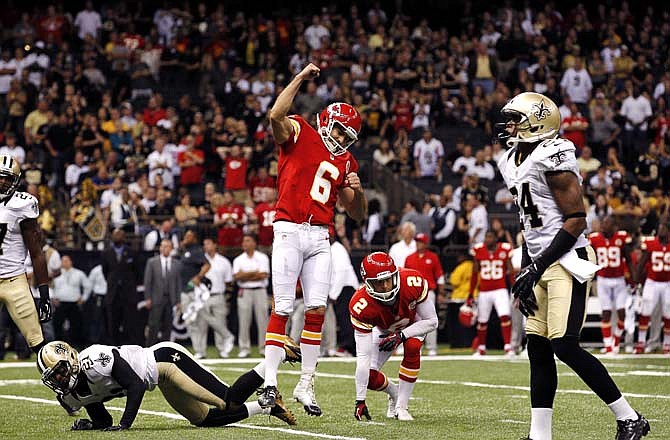 Chiefs kicker Ryan Succop celebrates his game-winning field goal as Patrick Robinson of the Saints falls to the turf in overtime Sunday in New Orleans.