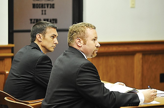 Defense attorney Scott Hamblin, looks to the judge as his client, Christopher Knehans, left, listens to the court proceedings Monday morning. Knehans pleaded guilty to charges filed against him.