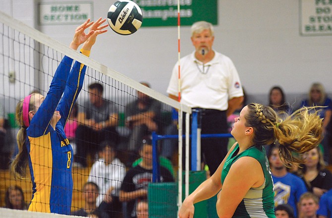 Fatima's Shelby Thoenen (left) blocks the ball as Blair Oaks' Riley Butler finishes her follow-through during Fatima's win Thursday at Blair Oaks.