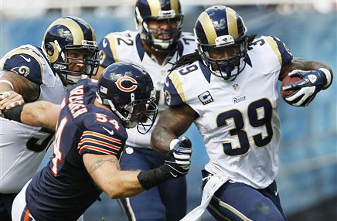 Rams running back Steven Jackson is chased by Chicago Bears linebacker Brian Urlacher in the second half of Sunday's game against the Bears in Chicago.