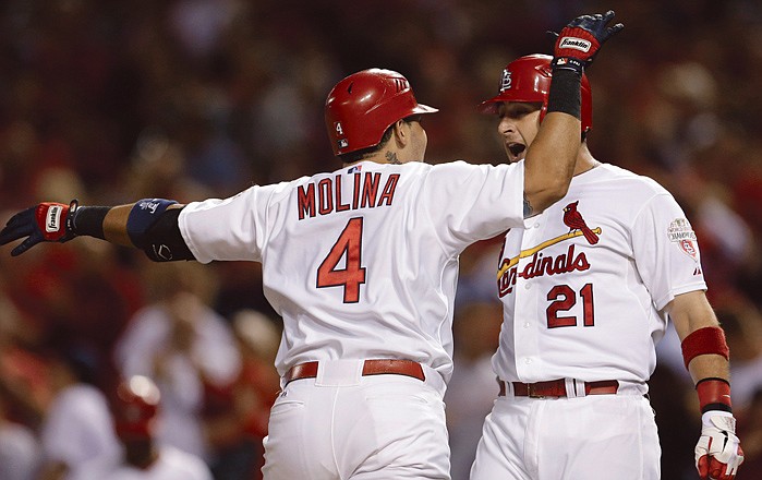 The Cardinals' Yadier Molina (4) is congratulated by teammate Allen Craig after hitting a two-run home run during the second inning against the Nationals on Friday in St. Louis. The Cardinals won 12-2.