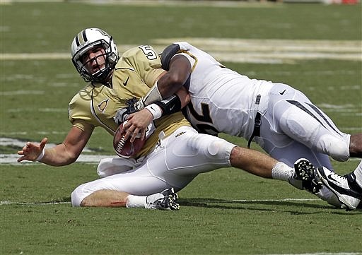 Central Florida quarterback Blake Bortles, left, is sacked by Missouri defensive lineman Michael Sam during the first half of an NCAA college football game, Saturday, Sept. 29, 2012, in Orlando, Fla. 