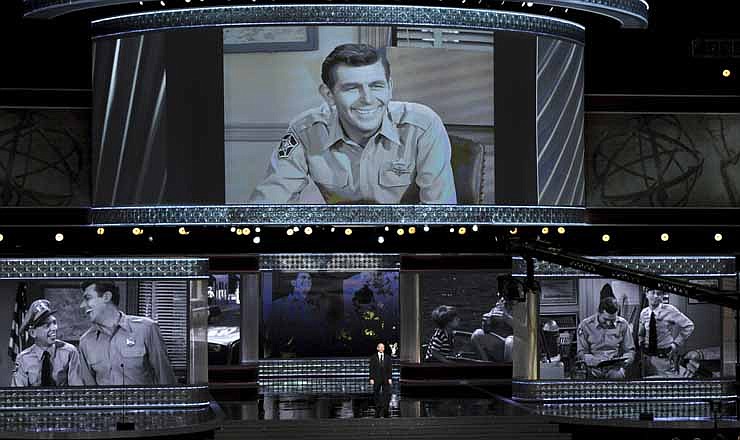 Ron Howard presents an "In Memorial" at the 64th Primetime Emmy Awards at the Nokia Theatre on Sunday, Sept. 23, 2012, in Los Angeles. Pictured onscreen is Andy Griffith.