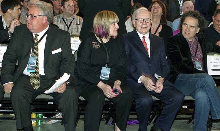 In this April 30, 2011, file photo, Berkshire Hathaway Chairman and CEO Warren Buffett, second right, sits with his children from left: Howard, Susie and Peter, at the Berkshire Hathaway shareholders meeting in Omaha, Neb. Buffett celebrated his 82nd birthday on Aug. 30, 2012, by giving each of his three children a big present: about $600 million worth of his company's stock for their charitable foundation.