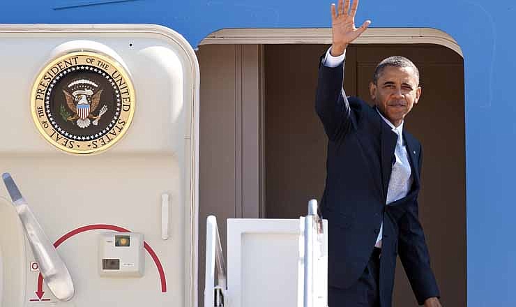 President Barack Obama waves as he boards Air Force One at Andrews Air Force Base, Md., Sunday, Sept. 30, 2012. Obama is traveling to Las Vegas for a campaign rally then will be staying in Nevada to prepare for the first presidential debate with Republican rival, former Massachusetts Gov. Mitt Romney, on Wednesday, Oct. 3, 2012. 