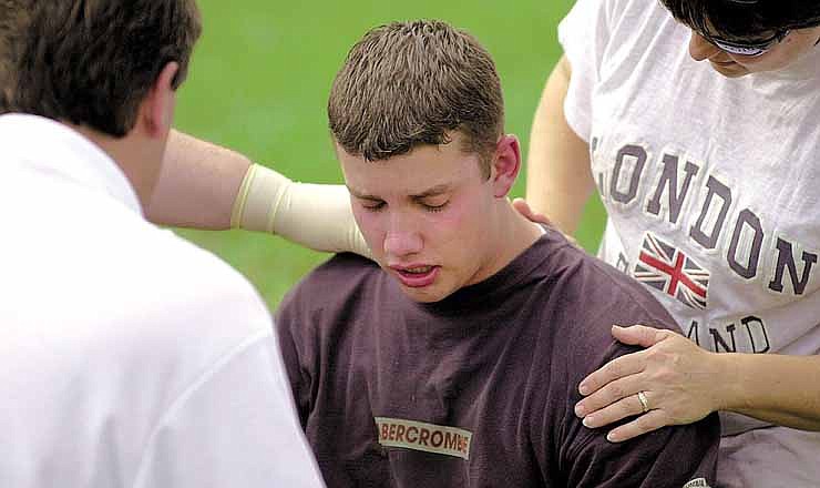  In this March 6, 2000 file photo, Joshua Wolf, a student at Jackson's R.O. Hawkins Junior High School, is comforted by emergency personnel after he escaped from a fire at his house north of Cape Girardeau, Mo. Wolf, now 28, sits in the Jefferson City Correctional Center 12 years into a life sentence without the possibility of parole for the shooting death of his grandmother and burning down their house. (AP Photo/The Southeast Missourian)