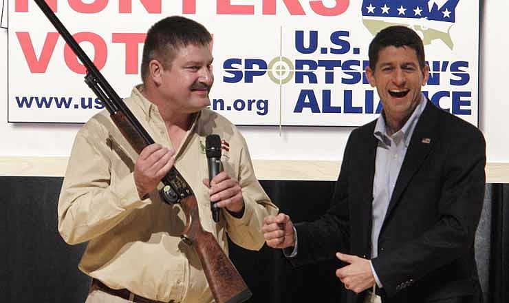 David Dlubak, left, owner of the Ithaca Gun Company, presents Republican vice presidential candidate, Rep. Paul Ryan, R-Wis., with a special edition Romney/Ryan Ithaca shotgun before Ryan speaks to the U.S. Sportsmen's Alliance annual banquet Saturday, Sept. 29, 2012, in Columbus, Ohio. A Romney/Ryan logo was engraved on the stock of the gun. 