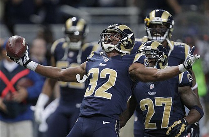 Rams cornerback Bradley Fletcher (32) reacts with Quintin Mikell (27) after intercepting a pass late in the fourth quarter of Sunday's game against the Seahawks at the Edward Jones Dome. The Rams improved to 2-2 with a 19-13 victory.