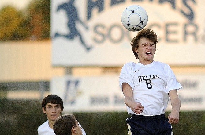 Helias defender Trevor Stumbaugh heads the ball away following a goal kick during Helias' win against Moberly on Monday at the 179 Soccer Park.