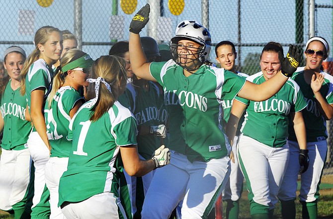 Amy Dorge is met by Blair Oaks teammate teammate LeeAnn Polowy (1) and the rest of the Lady Falcons after hitting a home run during Tuesday's game against the Southern Boone Lady Eagles at the Falcon Athletic Complex.