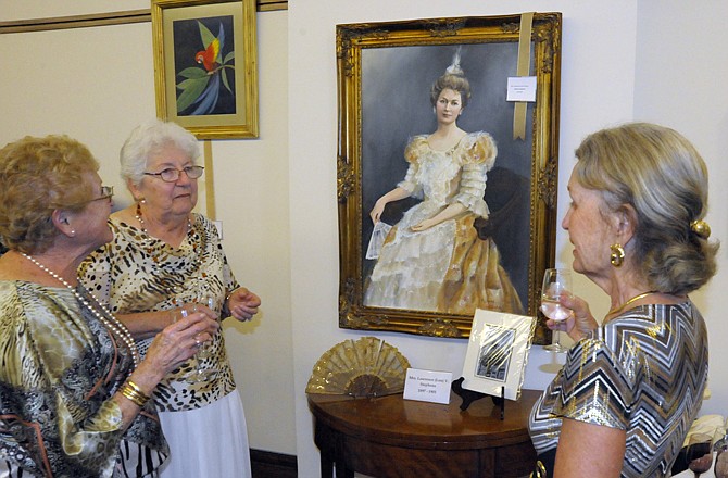 Lorraine Adkins, artist Kathryn Hajaved and Cathy Wilbers discuss the new painting of former first lady Margaret Stephens that Hajaved has donated to the Cole County Historical Society during an unveiling ceremony Tuesday at the CCHS.