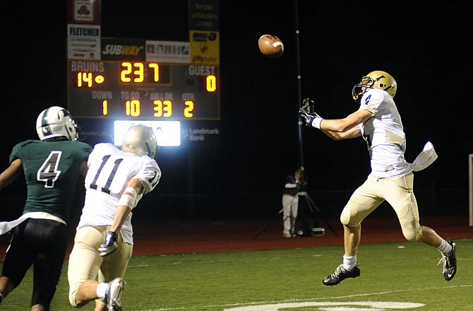 Helias safety Ryan Tannehill reaches out in an attempt to pull in an interception late in the first half of last Friday's game against Rock Bridge in Columbia. Rock Bridge receiver Alex Ofodile (4) and Helias defensive back Trent Dudenhoeffer watch on the play.