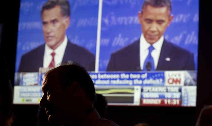 John Rossitto watches the first presidential debate between President Barack Obama and Republican presidential nominee Mitt Romney from a restaurant in San Diego, Wednesday, Oct. 3, 2012.