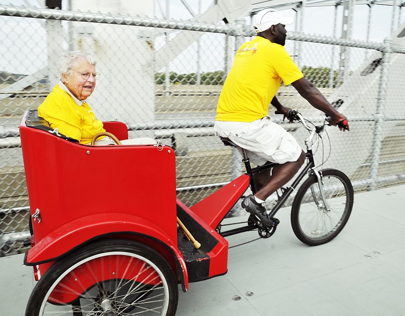 Pat Jones is driven across the pedestrian bridge as the third annual Pedal the Cause bike challenge made its way into Jefferson City this week. The ride is presented by Edward Jones to raise money for cancer research at the Siteman Cancer Center in St. Louis.