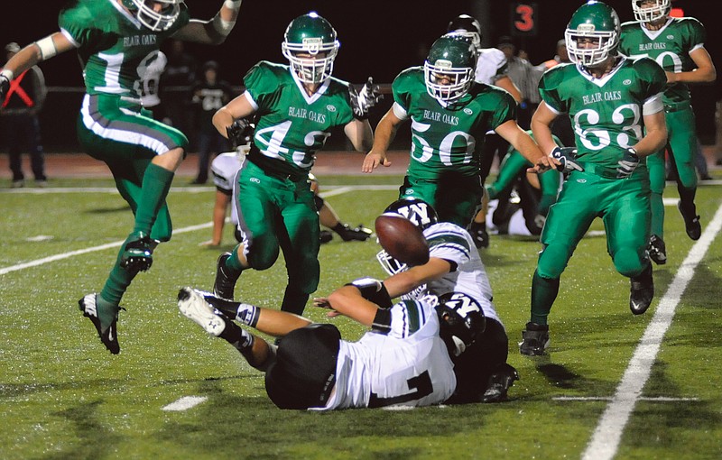 From left, Blair Oaks Falcons Mikel Drehle, Alex Gaydos, Hayden Haney and Dalton Fifer rush for a possible fumble by Warsaw on Friday night at the Falcon Athletic Complex. Blair Oaks won 65-12.