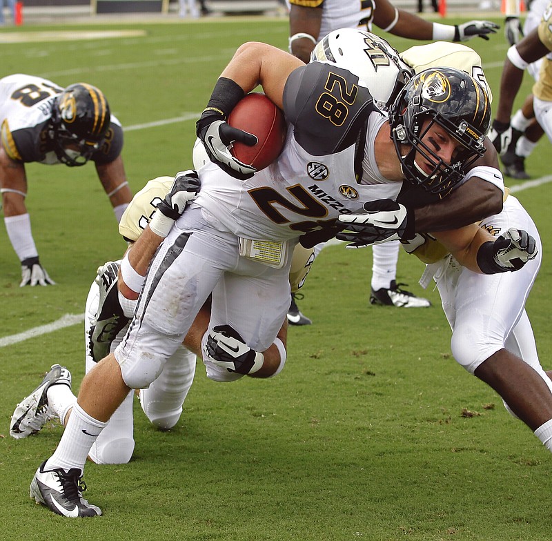 Missouri wide receiver T.J. Moe (28) is tackled after a short reception by Central Florida's Kevin Miller (right) and Jared Greenaway during the first half of Saturday's game in Orlando, Fla.